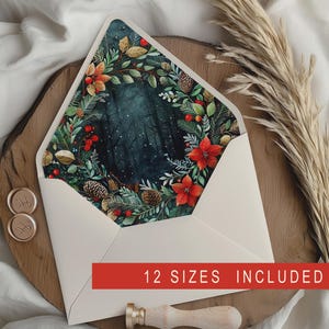 May include: A cream-coloured envelope with a forest scene inside, framed by a wreath of red poinsettias, green leaves, and pinecones. The text "12 SIZES INCLUDED" is on a red banner. Gold wax seals and a wax stamp are also present.