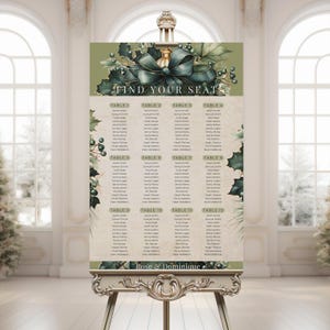 May include: A wedding seating chart displayed on a decorative easel. The chart features a green and gold design with the words "FIND YOUR SEAT" at the top. The names of guests are listed under table numbers. The names "Rose & Dominique" are at the bottom.