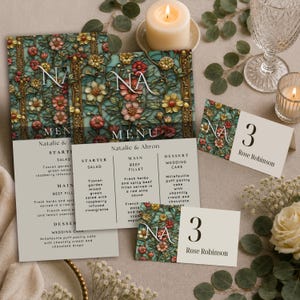 May include: A wedding stationery set featuring a menu and place cards with a floral stained glass pattern in shades of teal, red, and gold. The text includes the initials NA, the names Natalie & Ahron, and a menu listing starter, main, and dessert.