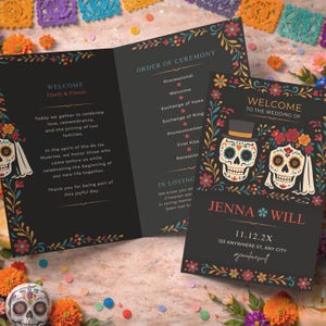 May include: A black wedding invitation suite featuring floral and skull designs. The invitation reads "Welcome to the Wedding of Jenna & Will" and "11.12.2X". The suite also includes the order of ceremony.