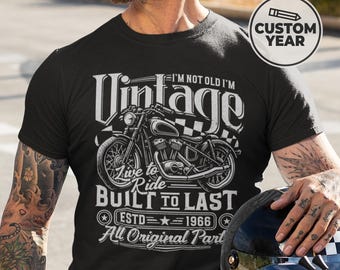May include: Black t-shirt with a vintage motorcycle graphic. The design includes the word "Vintage" above a motorcycle illustration, with text that reads "I'm not old I'm Vintage, Live to Ride, Built to Last, ESTD 1966, All Original Part."