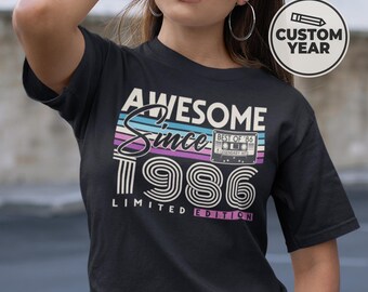 May include: Black t-shirt with the text "AWESOME Since 1986 LIMITED EDITION". The design includes a retro cassette tape graphic and a custom year option. The shirt has a vintage aesthetic.