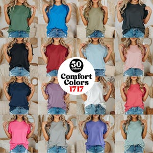 May include: A selection of t-shirts in a variety of colours, such as green, blue, black, red, and pink. The shirts are modelled. A circular graphic in the centre reads "50 Colors Comfort Colors 1717".