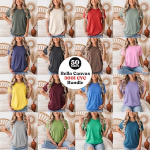 May include: A collection of Bella Canvas 3001 CVC t-shirts in 50 colors, featuring short sleeves and a crew neckline. The shirts are displayed in a grid format, showcasing various solid colors including red, blue, green, yellow, pink, and gray.