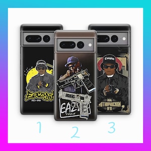 May include: Three phone cases with unique designs. The first case is black with a yellow sun and a graphic of a man in a hat. The second case is brown with a man holding a gun and the text "EAZY 1964". The third case is black with a man in a hat and the text "Compton".