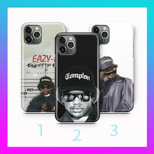 May include: Three phone cases with different designs. One case is white with a portrait, another is black with a portrait, and the third is off-white with text and a portrait. The cases feature the word "Compton".