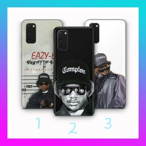 May include: Three phone cases with images of Eazy-E. The first case is off-white with text and a photo of Eazy-E. The second case is black with a photo of Eazy-E wearing a Compton hat. The third case is white with a photo of Eazy-E.