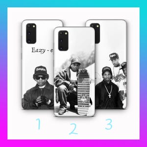 May include: Three white phone cases with black and white images of a rapper and group members. The first case has the text "Eazy-e" and a photo of a man wearing a Compton hat. The second case features a man with a skateboard. The third case shows a group of men.