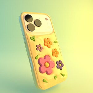 May include: A yellow phone case with a floral design. The case features a pattern of pink, orange, and purple flowers, along with green leaf accents. The phone case has a glossy finish and is designed to fit a smartphone.