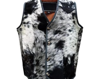 May include: A black and white cowhide vest with a black leather trim and buttons. The vest has a size tag that says "XL".