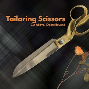 May include: Tailoring scissors with gold-toned handles and silver-toned blades, accompanied by a stem of three orange dried roses. The text Tailoring Scissors Cut Above. Create Beyond is displayed in orange lettering on a dark, textured background.