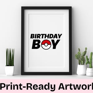 May include: A black framed print with the text "Birthday Boy" in black and white with a red and white Pokeball graphic in the center.