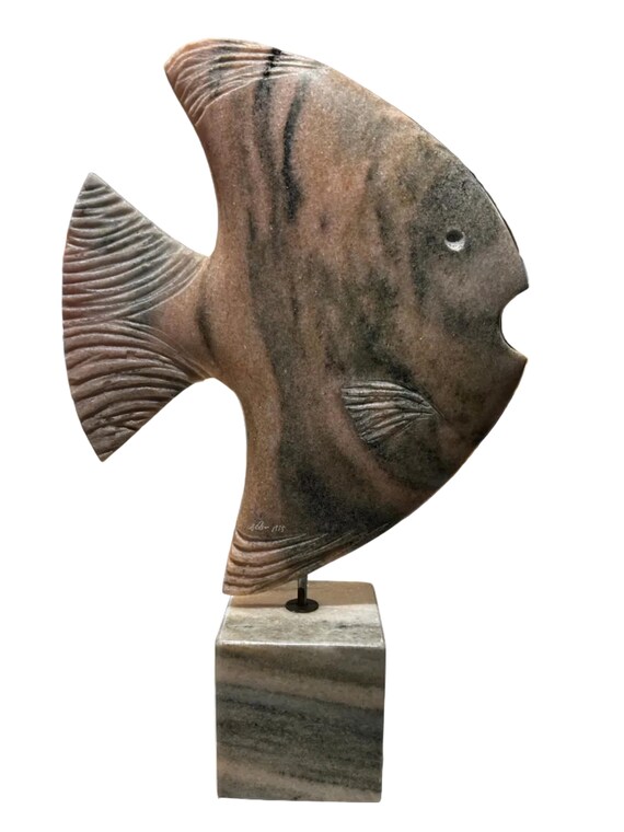 marble fish sculpture on stand