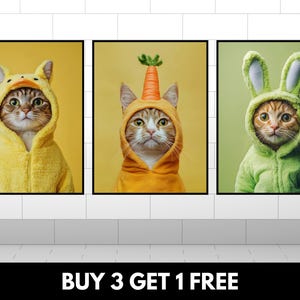 May include: Three framed prints of cats wearing costumes. The first cat is wearing a yellow duck costume. The second cat is wearing an orange carrot costume. The third cat is wearing a green bunny costume. The text "BUY 3 GET 1 FREE" is at the bottom of the image.