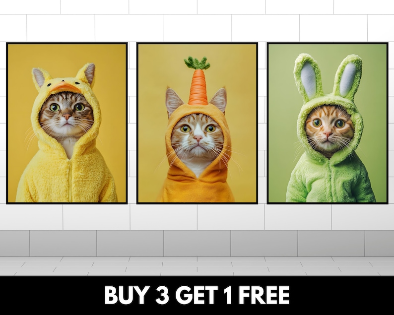 May include: Three framed prints of cats wearing costumes. The first cat is wearing a yellow duck costume. The second cat is wearing an orange carrot costume. The third cat is wearing a green bunny costume. The text "BUY 3 GET 1 FREE" is at the bottom of the image.