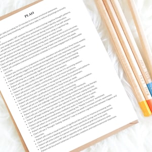 May include: A white paper with the word "PLAN" at the top, listing weekly goals for emotional awareness and mental health. Three pencils with the text "BOSS LADY" are on the right side, with orange, blue, and yellow accents.