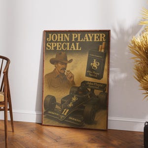 May include: Vintage-style poster with a sepia tone featuring the text "JOHN PLAYER SPECIAL." The poster includes an illustration of a man in a cowboy hat, a pack of cigarettes, and a black race car. The poster is framed.