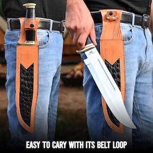 May include: A large hunting knife with a polished steel blade is shown in a leather sheath attached to a belt. The sheath is tan with a black, textured inlay. The text "EASY TO CARY WITH ITS BELT LOOP" is at the bottom.