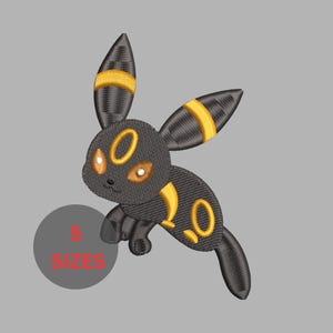 May include: An embroidered patch featuring a black creature with long ears, yellow ring markings on its ears, forehead, and body, and glowing orange eyes. A gray circular graphic with the red text 5 SIZES is positioned in the lower left corner.