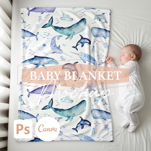 May include: A white baby blanket featuring watercolor illustrations of whales, dolphins, and narwhals in shades of blue and purple. The blanket has the words "BABY BLANKET" and "Mockup" printed on it.