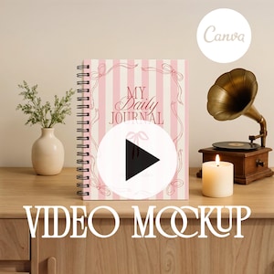 May include: A pink and white striped journal with the words "MY Daily JOURNAL" on the cover, decorated with pink bows. A vintage gramophone, a lit candle, and a vase with greenery are on a wooden surface.