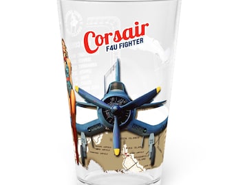 May include: A clear pint glass featuring a graphic of a blue F4U Corsair fighter plane, a pin-up figure, and a map background. The text reads Corsair F4U FIGHTER in red and blue lettering. The design includes a propeller and landing gear details.