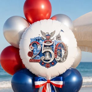 May include: A festive balloon bouquet with red, silver, and blue balloons. A large, round balloon in the center displays the text "250 AMERICA" with patriotic imagery. The bouquet is tied with red, white, and blue ribbons, perfect for a celebration.