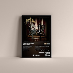 May include: A black and white album cover for Panic! At The Disco's album "Vices & Virtues". The album cover features two men in suits standing in front of a dark, ornate background. The album title is printed in white text at the bottom of the cover.