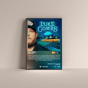 May include: A poster for Luke Combs' album "Gettin' Old." The poster features a photo of Luke Combs with a blue neon sign that reads "LUKE COMBS." The album cover is a blue and green landscape with a house in the distance. The album tracklist is listed below the photo.