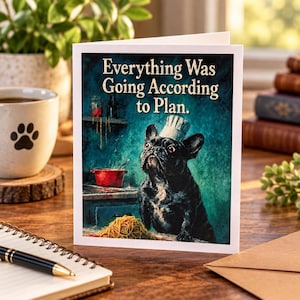 May include: A greeting card featuring a black French Bulldog wearing a chef hat in a kitchen setting with a pile of spaghetti on the counter. The text on the card reads, Everything Was Going According to Plan. The background is a dark teal color.