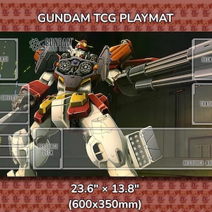 May include: Gundam TCG playmat featuring a detailed illustration of a Gundam robot with large cannons. The playmat has designated areas for cards, measuring 23.6" x 13.8". The background is a repeating pattern of cartoon characters.