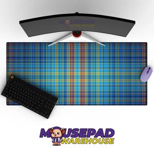 May include: A large rectangular mousepad with a blue, yellow, and orange plaid pattern. A black keyboard and a light purple mouse are on the pad. A curved computer monitor is above the pad. The mousepad has the text "MOUSEPAD WAREHOUSE".