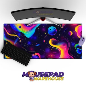 May include: A vibrant, large rectangular mousepad with a colorful space-themed design. The pad features swirling nebulae in shades of purple, blue, yellow, and pink. A black keyboard and a light purple mouse are on the pad. The text "MOUSEPAD WAREHOUSE" is visible.