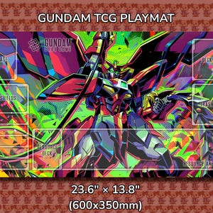 May include: Gundam TCG playmat featuring a colorful illustration of a Gundam robot. The playmat has designated areas for gameplay, including "Base," "Shields," and "Deck." It measures 23.6" x 13.8" (600x350mm).