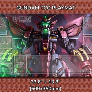 May include: Gundam TCG playmat featuring a detailed illustration of a Gundam robot in shades of red, pink, and gray. The playmat has designated areas for cards and measures 23.6" x 13.8". The text "GUNDAM TCG PLAYMAT" is at the top.