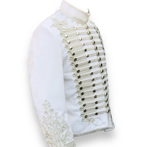 May include: A white jacket with gold buttons and intricate embroidery on the sleeves and collar.