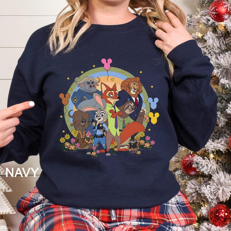 May include: Navy blue sweatshirt with a vibrant graphic of animated characters. The design includes a rainbow, flowers, and the word "NAVY" at the bottom left. The sweatshirt has a crew neck and long sleeves.