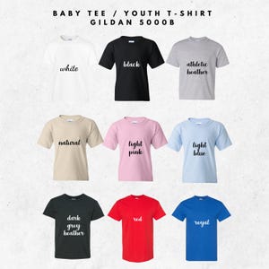 May include: Nine baby and youth t-shirts in various colors, including white, black, and red. Each shirt has a different color name printed on it in a cursive font. The shirts are arranged in a grid.