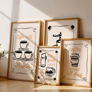 May include: Four framed art prints with coffee-themed illustrations and text. The prints feature line drawings of coffee cups, a thermos, and a coffee maker. Text includes "Coffee with Friends", "Take a quiet moment", and "coffee served all day".