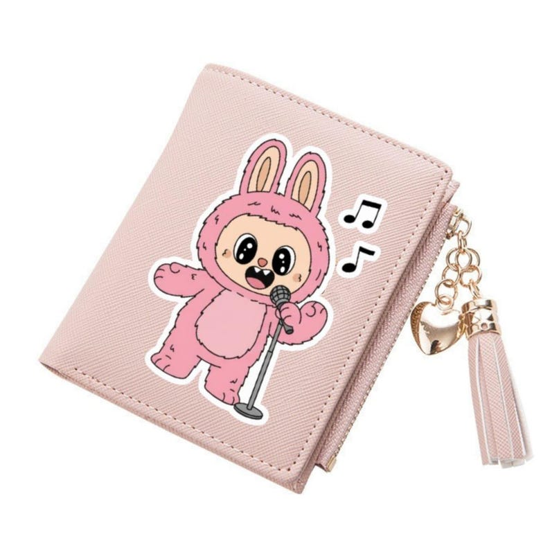 May include: A light pink bi-fold wallet featuring a cartoon bunny character in a pink outfit holding a microphone. The wallet has a zipper closure and a gold-colored charm with a heart and tassel. Musical notes are also visible.