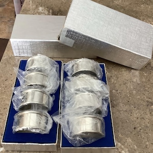 May include: A set of three ceramic mugs with a speckled, matte finish. The mugs are in shades of cream, light gray, and dark gray. Each mug has a simple, minimalist design, perfect for coffee or tea.