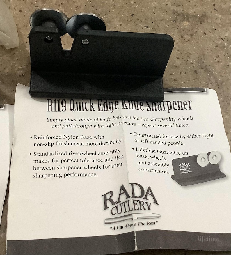 May include: Black R119 Quick Edge knife sharpener with two sharpening wheels. The sharpener has a reinforced nylon base and is designed for use by right or left-handed people. The product includes the text "RADA CUTLERY" and "A Cut Above The Rest."