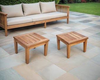 May include: Two square wooden end tables with a slatted top. The tables are made of natural wood and have a light brown colour. The tables are sitting on a light grey tiled patio.
