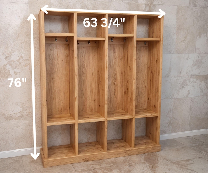 May include: A wooden storage unit with multiple compartments, shelves, and hooks. The unit is 76 inches tall and 63 3/4 inches wide. It is constructed from light-colored wood and has a natural finish, suitable for organizing items.