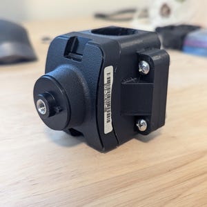 May include: Black plastic camera mount with a threaded hole and a barcode label that reads "017C-31RB-00".