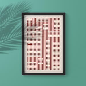 以下が含まれることがあります： 赤と白の幾何学模様の額入りアートプリント。アートワークは、垂直線と小さな正方形のパターンをオフホワイトの背景に配置しています。フレームは黒で、プリントはターコイズの壁に表示されています。
