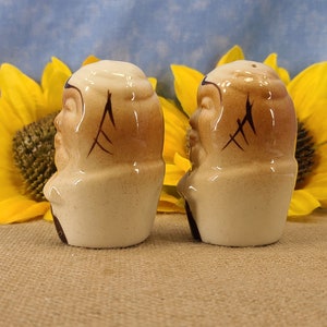 Left side view Vintage Bald Man Salt and Pepper Shakers Hand Painted - Unmarked, though maybe from Japan. From the 50s, they are in near mint condition with both stoppers. They are 3 inches high by 1.83 inches wide with no crazing.