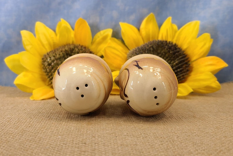 Top view of Vintage Bald Man Salt and Pepper Shakers Hand Painted - Unmarked, though maybe from Japan. From the 50s, they are in near mint condition with both stoppers. They are 3 inches high by 1.83 inches wide with no crazing.