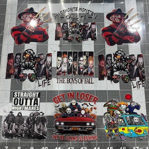 May include: A collection of horror-themed decals featuring Freddy Krueger, various slasher movie characters, and text including "My Favorite Monsters Call Me Mom," "Life," "The Boys of Fall," "Straight Outta Nightmares," and "Get In Loser We're Going Slashing."