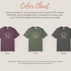 May include: Three t-shirts in berry, moss, and pepper colors, each with a graphic that reads "STUPID CANADIAN WOLF BIRD." The image includes the text "Color Chart" and details about the fabric.